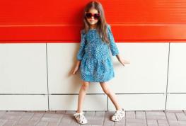 Beautiful little girl model wearing a leopard dress and sunglass